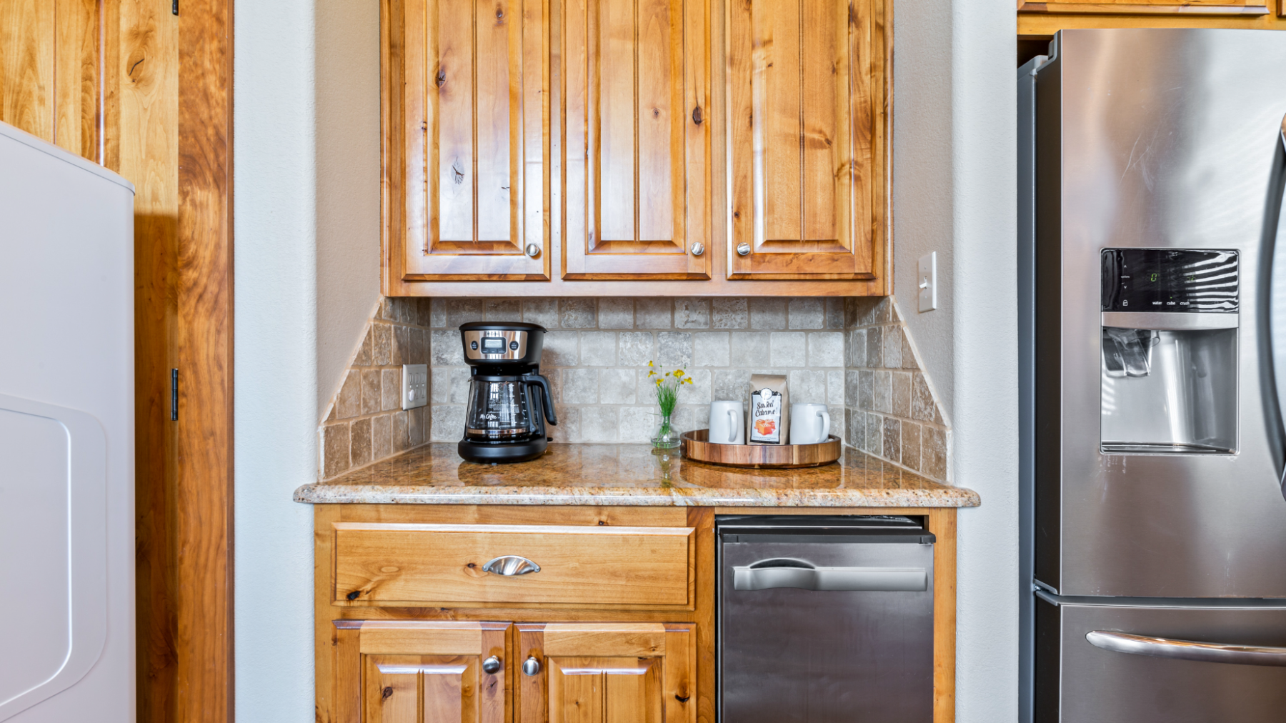 a kitchen with stainless steel appliances and wooden cabinets